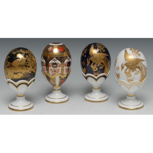 159 - A Royal Crown Derby Black and Gold Aves egg and stand, boxed; others, Blue and Gold Aves, Gold Aves ... 