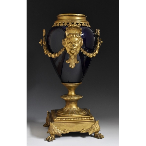 1689 - A 19th century gilt metal mounted earthenware ovoid lamp, cast and applied with ribbon-tied swags an... 