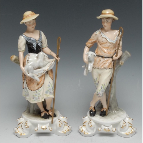 169 - Royal Crown Derby figures, The Shepherd and Shepherdess, they both stand wearing broad brimmed hats,... 