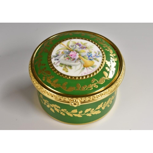 172 - A Lynton circular table box, painted by Stefan Nowacki, signed, with a musical trophy and a bouquet ... 