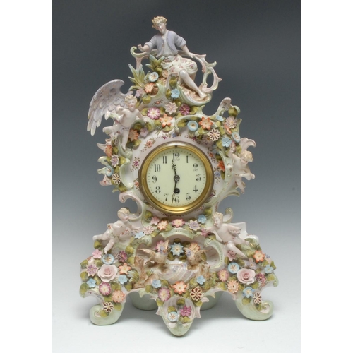 247 - A large German porcelain mantel clock, the 9.5cm dial with Arabic numerals, the elaborate scroll cas... 