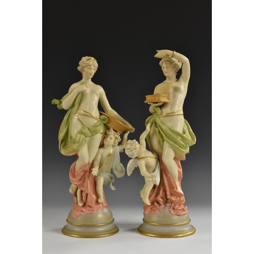 256 - A pair of Austrian Royal Dux figure groups, of classical maidens, with cherubs, both scantily draped... 