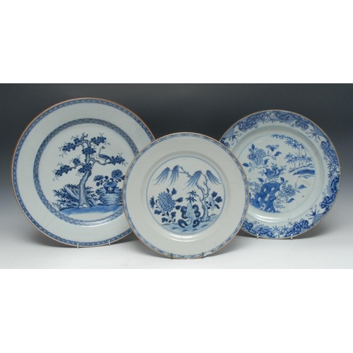 310 - A Chinese circular charger, decorated in underglaze blue with a bird perched in a pine tree, trellis... 