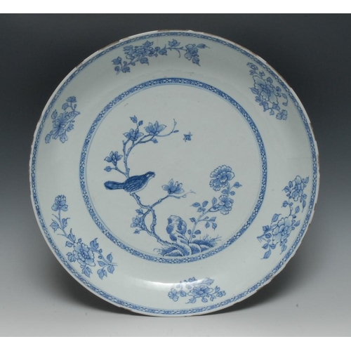 312 - A Chinese circular charger, decorated in underglaze blue with song bird perched on magnolia, the rim... 