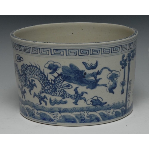 320 - A Chinese cylindrical jardiniere, painted in tones of underglaze blue with verse inscription and dra... 