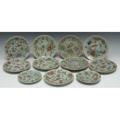 350 - Nine Cantonese circular plates, each decorated in polychrome with fanciful birds and flowers on a ce... 