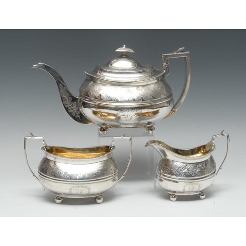 503 - A George III Provincial silver three piece boat shaped tea service, comprising teapot, milk jug and ... 