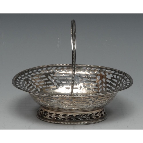 518 - A George III silver oval swing-handled sweetmeat basket, beaded borders, the side pierced and engrav... 