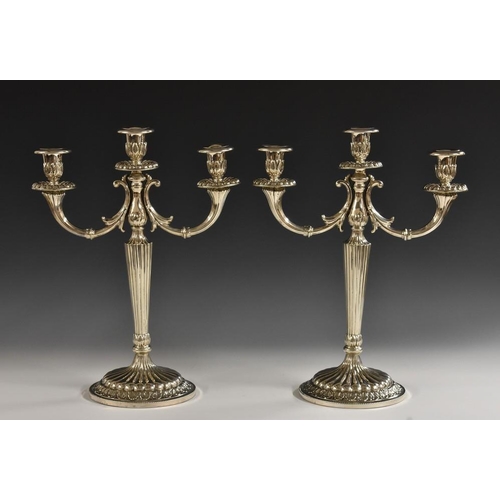 583 - A pair of Italian silver three-light candelabra, campana sconces, scroll branches, tapered pillars, ... 