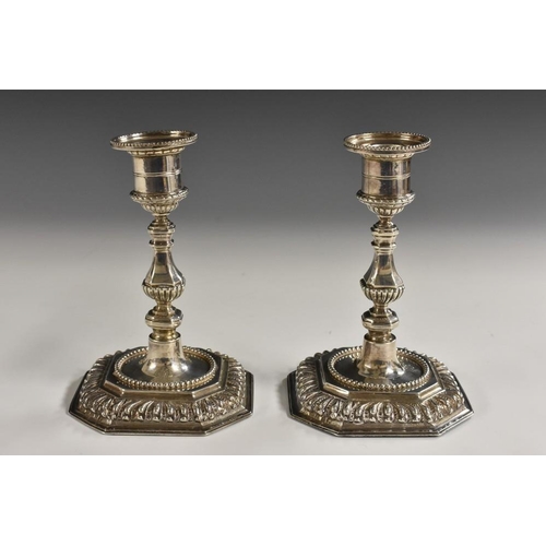 586 - A pair of Victorian silver candlesticks, of George I design, campana sconce, canted square bases, 15... 