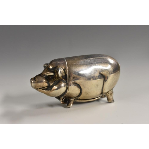 595 - A silver novelty vesta case, as a pig, hinged head, striker to base, marked 925, 6.5cm long