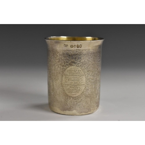 603 - A Victorian silver flared cylindrical beaker, chased overall with faux snakeskin texture and inscrib... 