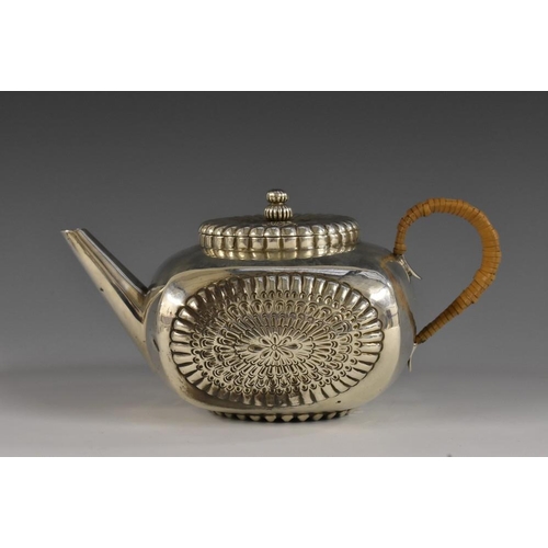 666 - An unusual Aesthetic Movement silver bowed square bachelor's teapot, embossed with lotus, cane-wrapp... 