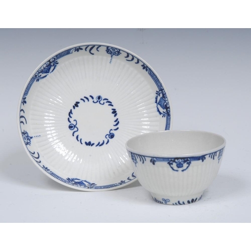 68 - A Worcester reeded tea bowl and saucer, painted in blue with flower spray within a formal border, cr... 