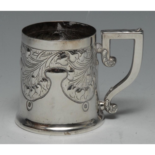 690 - An Arts and Crafts silver spreading cylindrical christening mug, embossed with stylised leaves and o... 