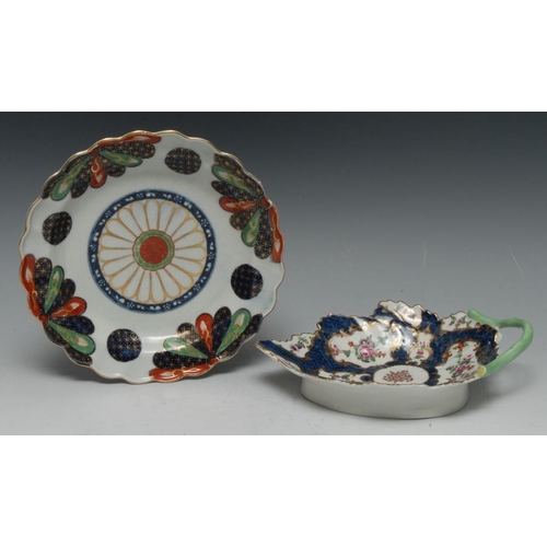 77 - A Worcester leaf moulded dish, branch handle, painted with flowers and foliage within alternating  f... 