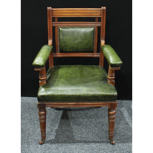 394 - An Edwardian mahogany open arm chair, stuffed over leather upholstery, turned forelegs, sabre back l... 