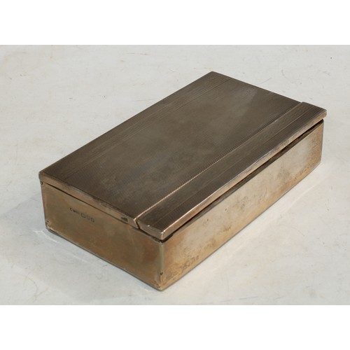 517 - A silver rectangular cigarette box, engine turned, pop-up mechanism, Chester 1931, 15.5cm wide