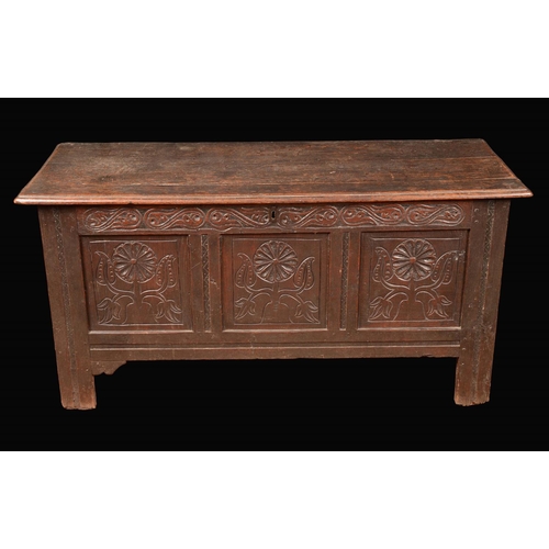 785 - A Charles II oak blanket chest, rounded rectangular top enclosing a till, the front carved with styl... 