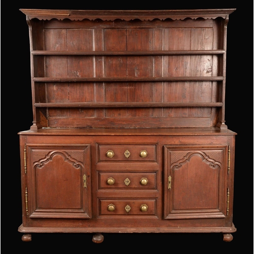 786 - A French Provincial oak dresser, the associated 18th century top with outswept cornice above three l... 