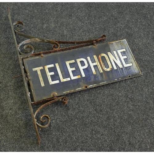 795 - An early 20th century enamel police telephone sign on wrought wall bracket c.1930