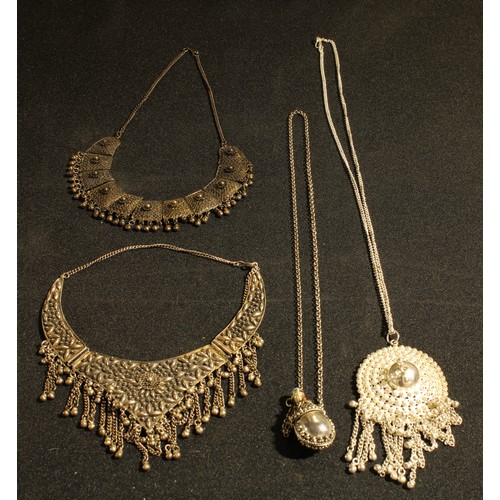 549 - Jewellery - an ornate white metal necklace; others similar; white metal scent bottle on neckchain (4... 