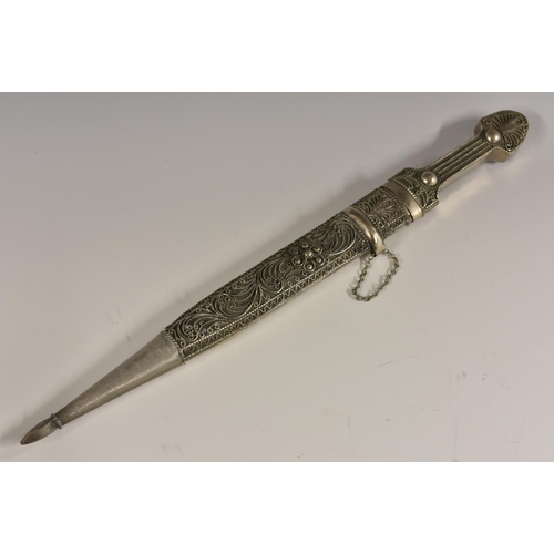 3059 - A Caucassian silvered metal qama dagger, 24.5cm pointed blade, the scabbard and haft applied with wi... 