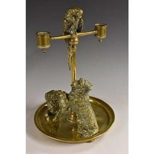 3081 - A large 19th century brass novelty animalier desk companion, the posted two-light candelabra surmoun... 