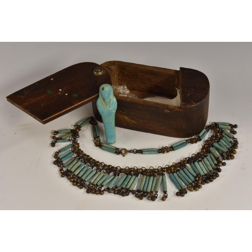 3500 - Antiquities - an Egyptian turquoise faience ushabti, 6cm long; a set of mummy beads, similar, later ... 