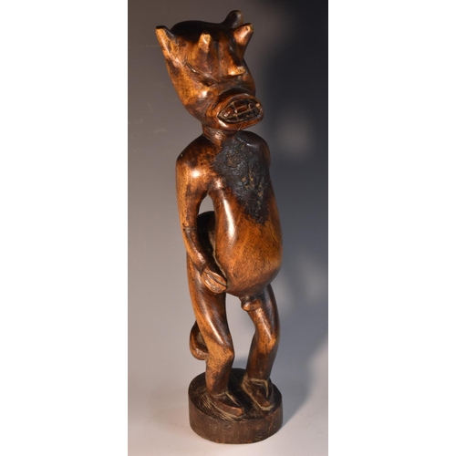 3515 - Tribal Art - an African carving, of a horned demonic figure, 35.5cm high