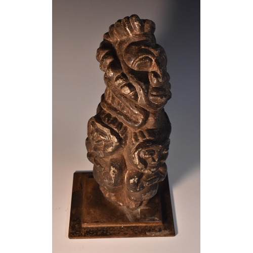 3524 - Tribal Art - an African stone carving, depicting a stylised face above four figures, 27cm high