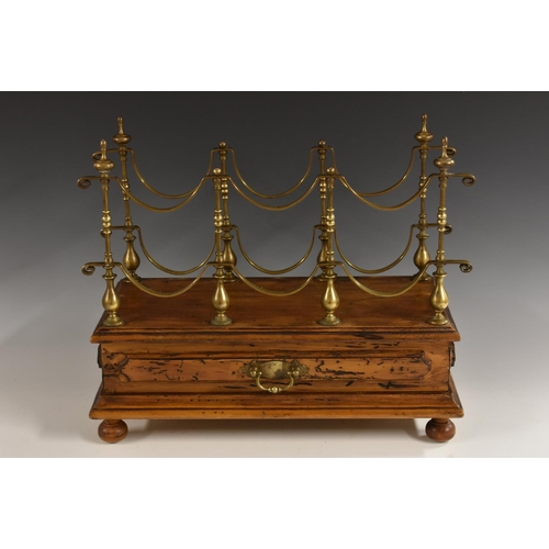 3532 - A French Provincial walnut and brass wine rack, the shaped superstructure with provision for six bot... 