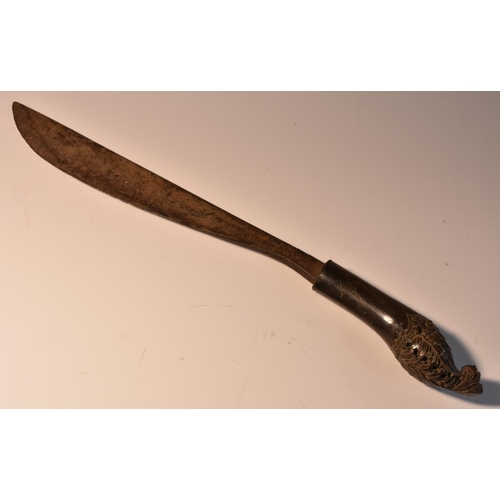 3544 - An Indonesian parang type dagger, 23.5cm curved single-edged blade, the horn grip carved with stylis... 