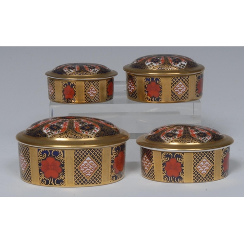 104 - A graduated set of four Royal Crown Derby 1128 pattern oval trinket jars and covers, solid gold band... 