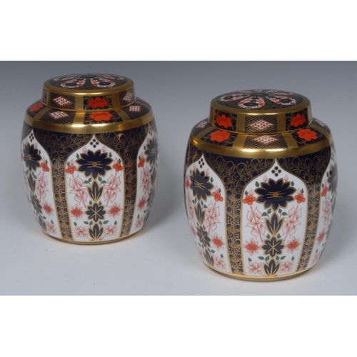 108 - A pair of Royal Crown Derby 1128 pattern ginger jars and covers,  solid gold bands, 18.5cm high, pri... 