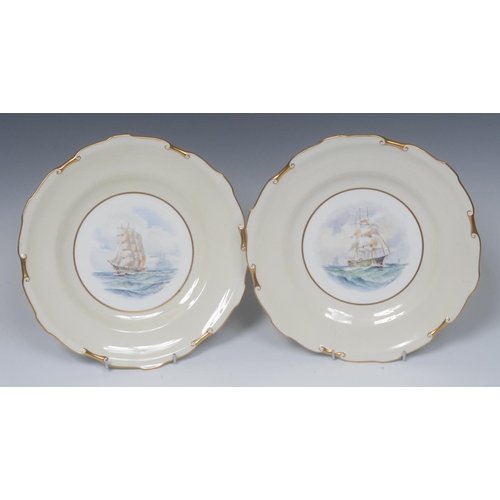 120 - A pair of Royal Crown Derby circular plates, painted by W. E. J. Dean, signed,  with galleons at sea... 