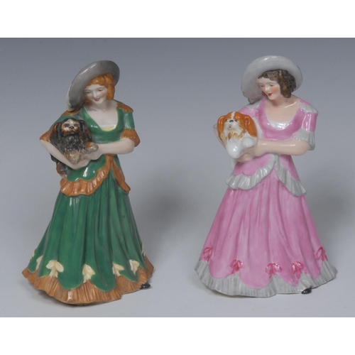 130 - A Royal Crown Derby figure, Marjorie, wearing a broad brimmed hat and pink dress, holding a dog, 16.... 