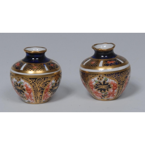 150 - A pair of Royal Crown Derby 6299 pattern miniature/toy globular vases, wavy rims, 3.5cm high, printe... 