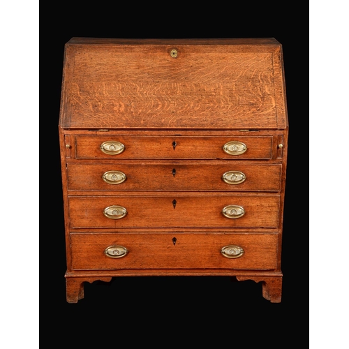 1572 - A George III oak bureau, fall front enclosing a cupboard and an arrangement of pigeon holes and smal... 