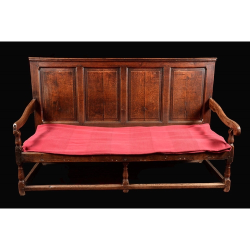 1577 - A George III oak settle, rectangular back with four raised and fielded rectangular panels, scroll ar... 