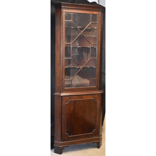 1581 - A George III Revival mahogany floor-standing splay-fronted corner display cabinet, stepped cornice a... 