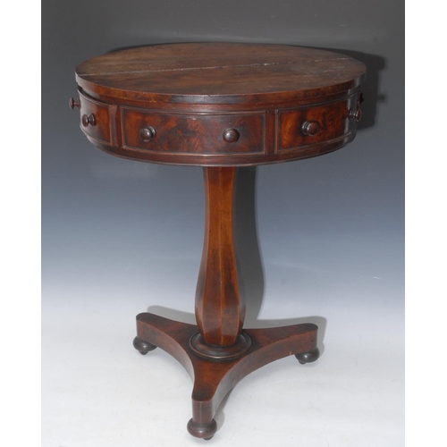 1587 - A George IV mahogany circular drum table, of small proportions, slightly oversailing above a deep fr... 