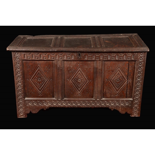 1601 - A late 17th century oak three-panel blanket chest, hinged top, the front with nulled frieze and carv... 