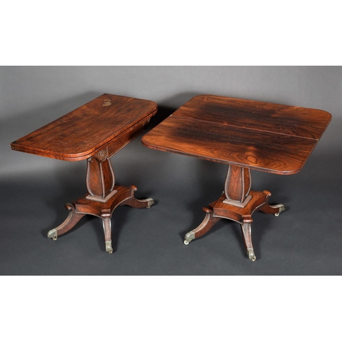 1618 - A pair of Regency rosewood rounded rectangular tea tables, each folding top above a deep frieze flan... 