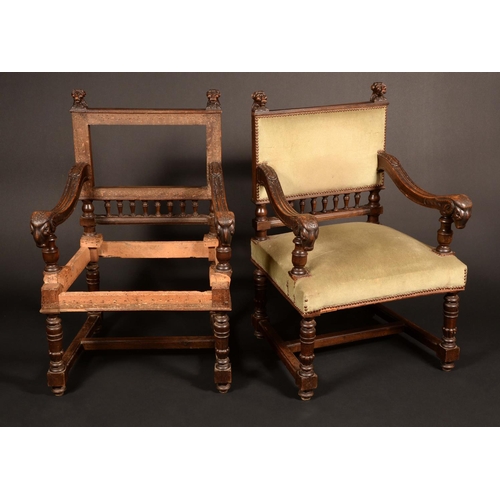 1619 - A pair of Renaissance Revival walnut armchairs, each rectangular back with heraldic lion finials, sc... 