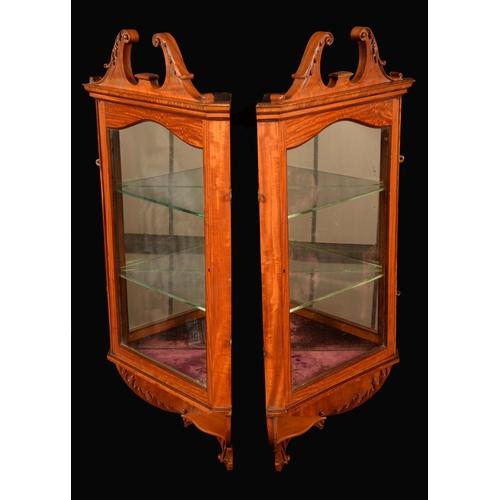 1620 - A pair of Sheraton Revival satinwood wall hanging corner display cabinets, each with swan neck pedim... 