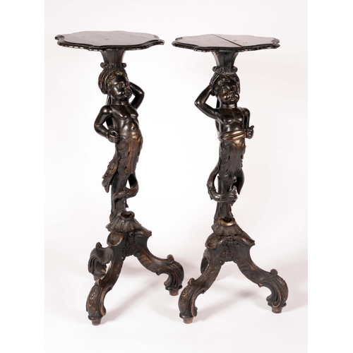 1621 - A pair of Venetian Blackamoor torcheres, each with shaped plateau above a scantilly clad attendant, ... 