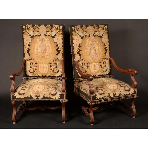 1622 - A pair of William and Mary style walnut arm chairs, tall rectangular backs, serpentine arms terminat... 