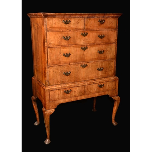 1623 - A Queen Anne/George I walnut chest on stand, moulded outswept cornice above two short and three long... 