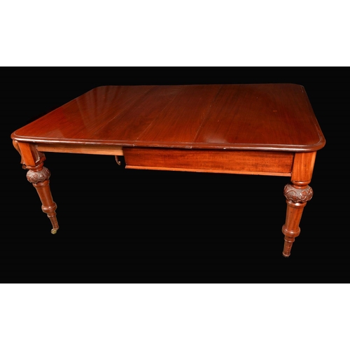 1647 - A Victorian mahogany rectangular wind-out dining table, moulded top above a deep frieze, turned legs... 